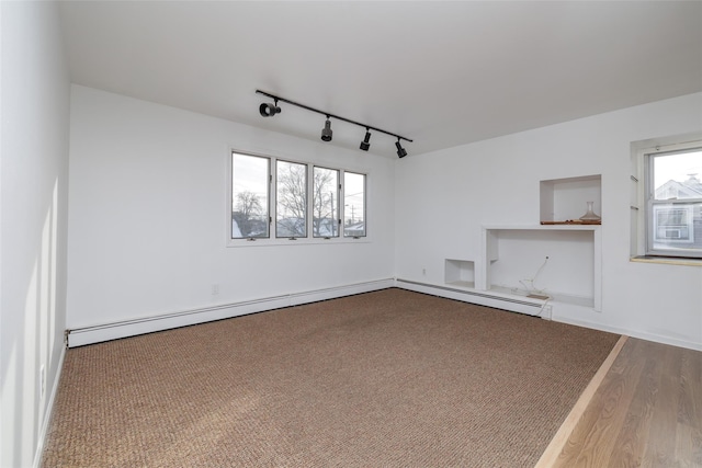 spare room with rail lighting and hardwood / wood-style floors