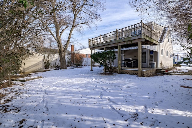 view of snow covered rear of property