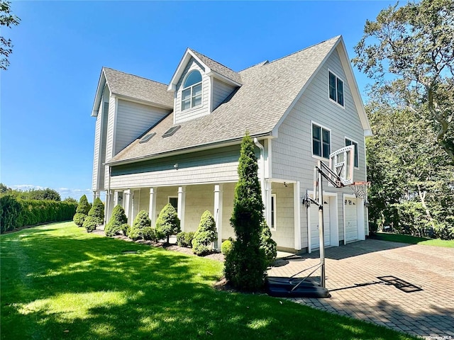 exterior space featuring a garage and a yard