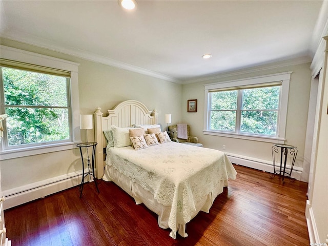 bedroom featuring baseboard heating, multiple windows, and crown molding