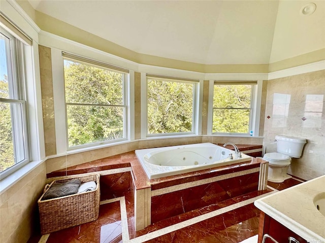 bathroom featuring tile walls, toilet, a relaxing tiled tub, vanity, and lofted ceiling