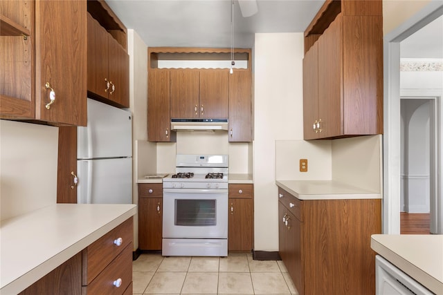 kitchen featuring white appliances and light tile patterned floors