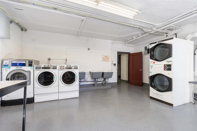 laundry area featuring stacked washing maching and dryer, separate washer and dryer, and sink