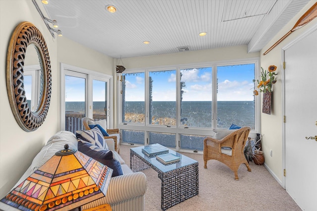 sunroom with a water view and plenty of natural light