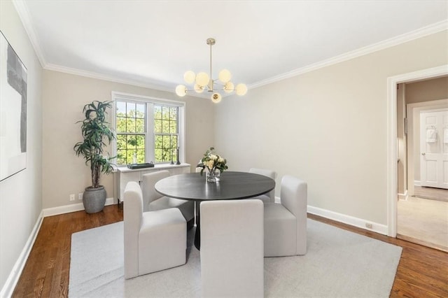 dining area featuring dark hardwood / wood-style flooring, ornamental molding, and a chandelier