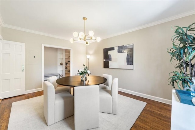 dining space with dark wood-type flooring, crown molding, and a chandelier