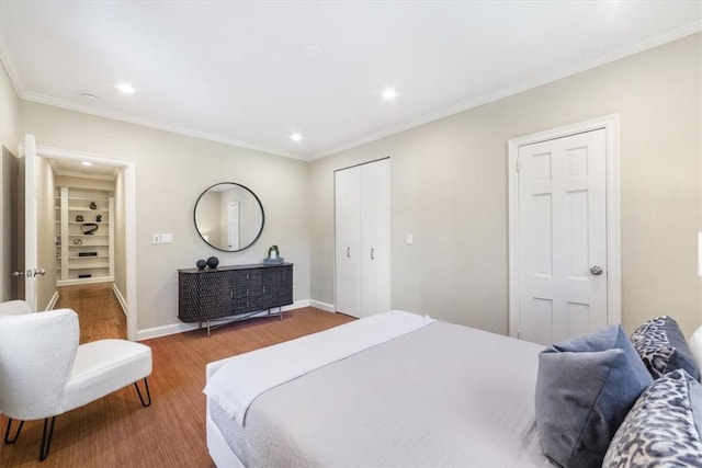 bedroom with crown molding and hardwood / wood-style floors