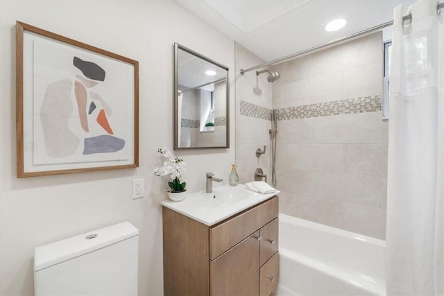 full bathroom featuring toilet, vanity, and shower / bath combination with curtain