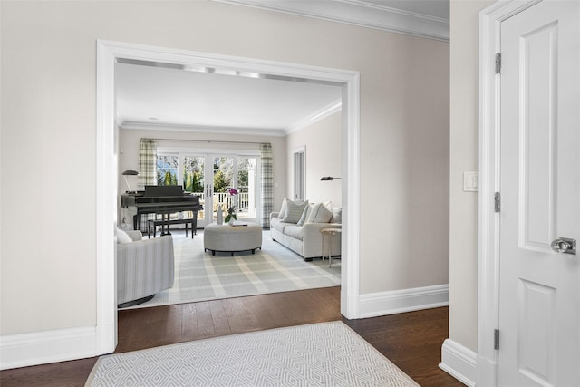 hallway featuring ornamental molding, baseboards, and wood finished floors