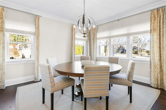 dining space with wood finished floors, baseboards, a chandelier, and ornamental molding