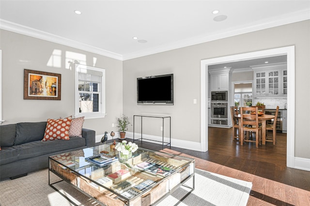 living area with recessed lighting, wood-type flooring, baseboards, and ornamental molding