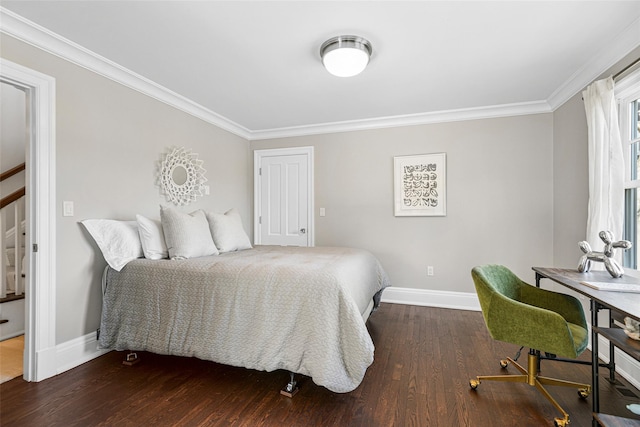 bedroom featuring baseboards, wood finished floors, and crown molding