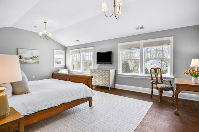 bedroom featuring vaulted ceiling, wood finished floors, visible vents, and a chandelier