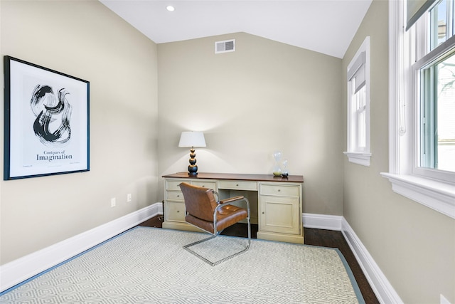 office space with visible vents, baseboards, wood finished floors, and vaulted ceiling