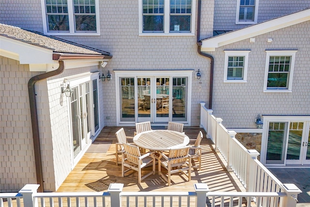 wooden deck with outdoor dining space and french doors