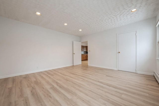 unfurnished room with light hardwood / wood-style flooring