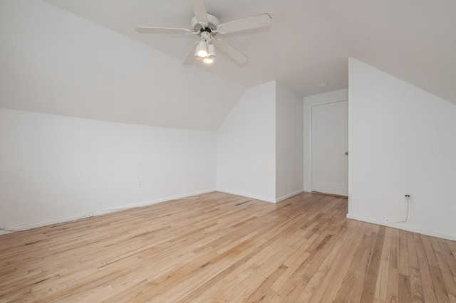 additional living space with ceiling fan, light wood-type flooring, and vaulted ceiling