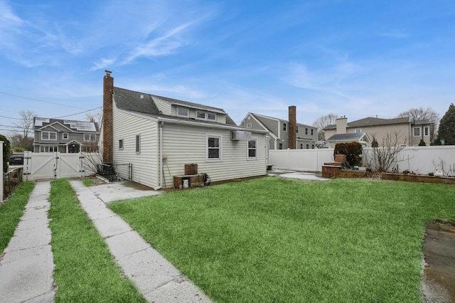 back of house featuring a yard