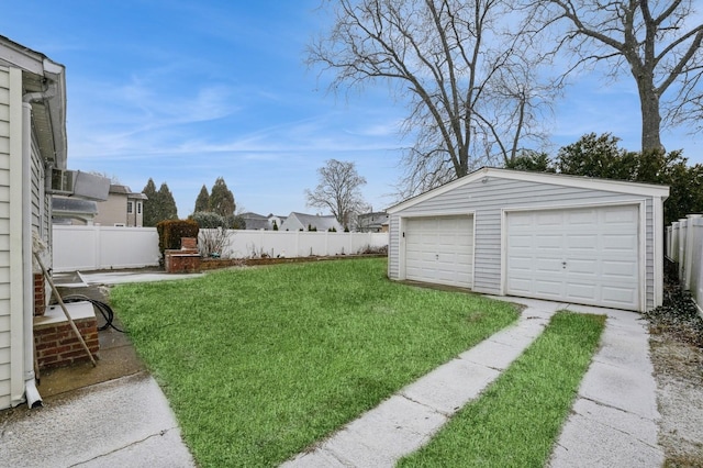 view of yard with a garage and an outbuilding