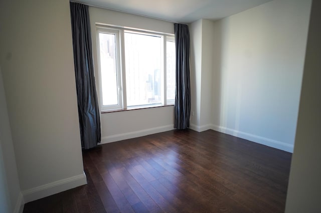 empty room with dark wood-type flooring