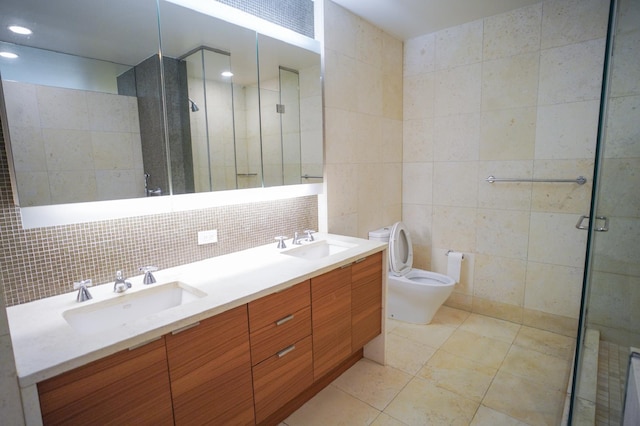 bathroom with vanity, tile walls, an enclosed shower, and tile patterned floors