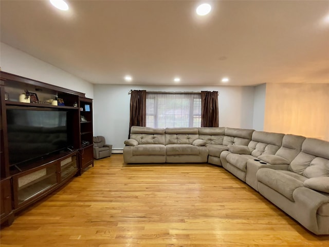 living room with a baseboard radiator and light hardwood / wood-style floors