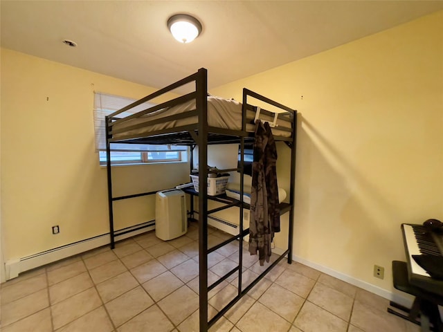 tiled bedroom featuring a baseboard heating unit