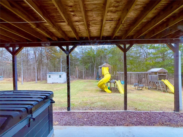 view of patio / terrace with a shed and a playground