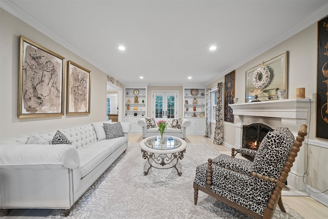 living room with crown molding, built in features, and french doors