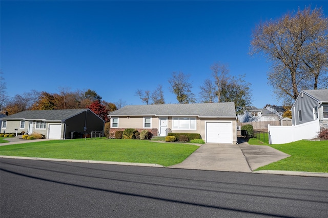 ranch-style house featuring a front lawn and a garage