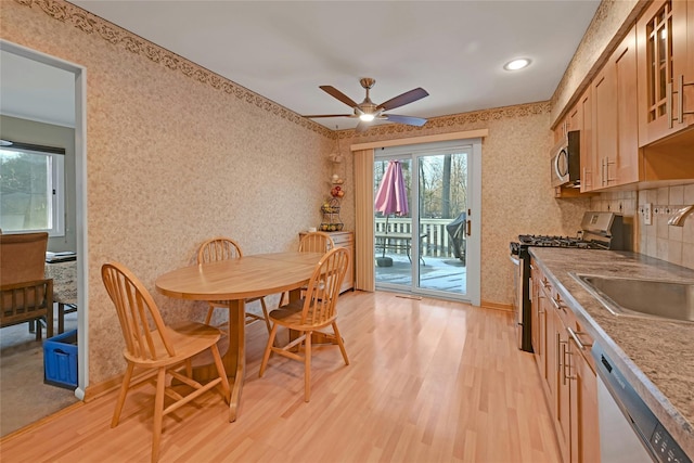 dining room with sink, light hardwood / wood-style floors, and ceiling fan