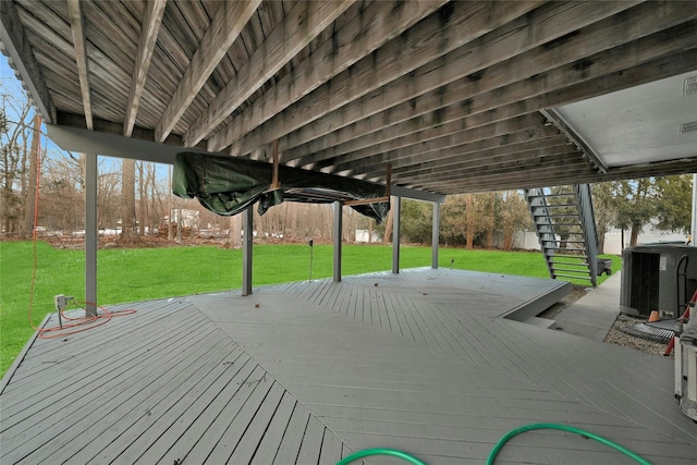 deck with central AC unit and a lawn