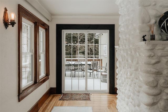 doorway to outside featuring crown molding