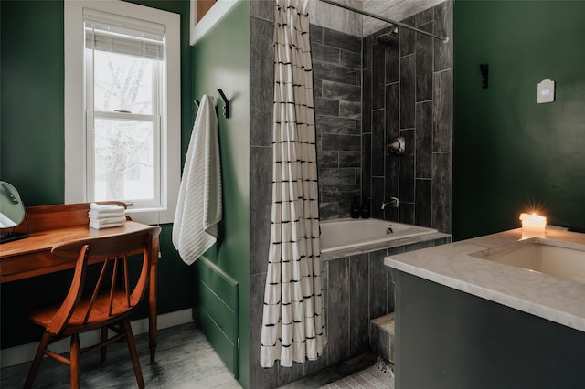 bathroom with hardwood / wood-style floors, vanity, and shower / bath combo