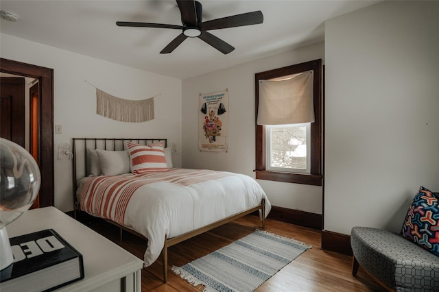 bedroom with ceiling fan and hardwood / wood-style floors