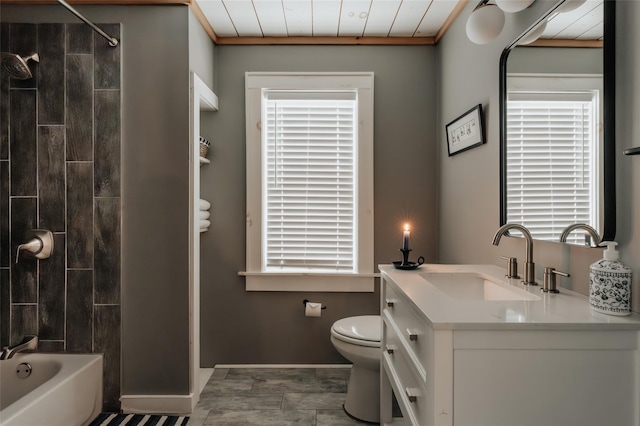 full bathroom featuring toilet, vanity, ornamental molding, and tiled shower / bath