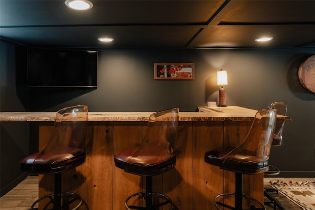 bar with light hardwood / wood-style floors