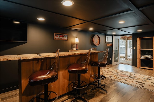 bar featuring light hardwood / wood-style floors