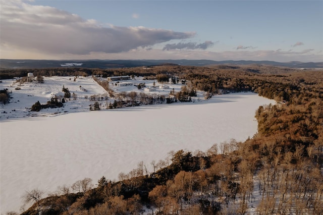 snowy aerial view with a mountain view