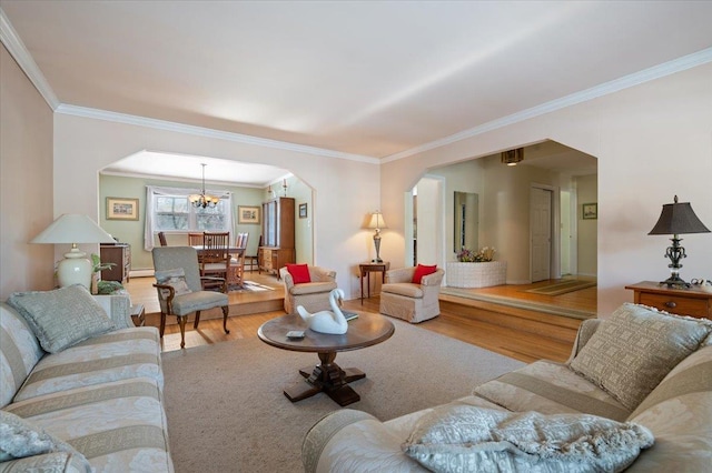 living room with hardwood / wood-style flooring, crown molding, and a notable chandelier