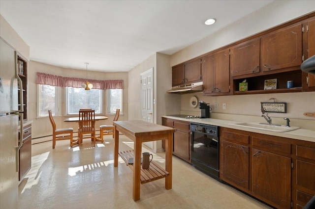 kitchen featuring sink, black appliances, and hanging light fixtures