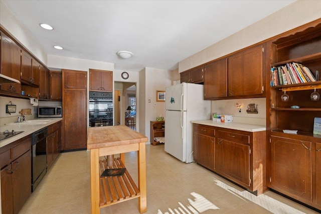 kitchen with sink and black appliances