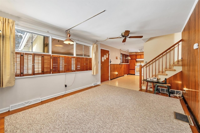 spare room featuring ceiling fan and wooden walls