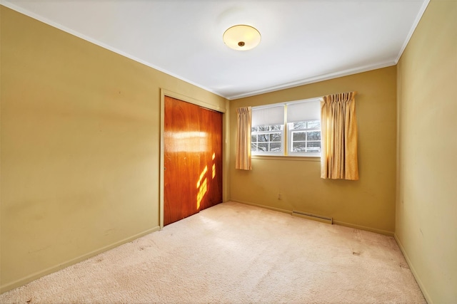 unfurnished bedroom with a closet, carpet flooring, and crown molding