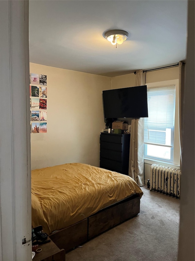 carpeted bedroom with radiator