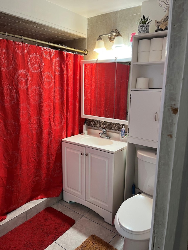 bathroom featuring toilet, vanity, tile patterned floors, and walk in shower