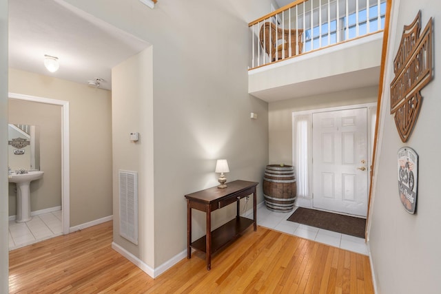 foyer featuring sink and light hardwood / wood-style flooring