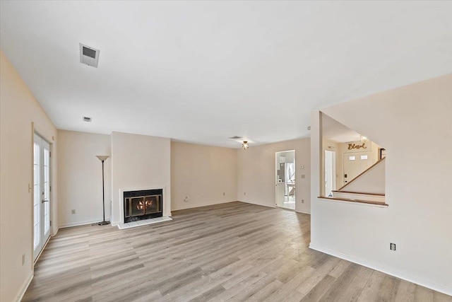 unfurnished living room featuring light wood-type flooring