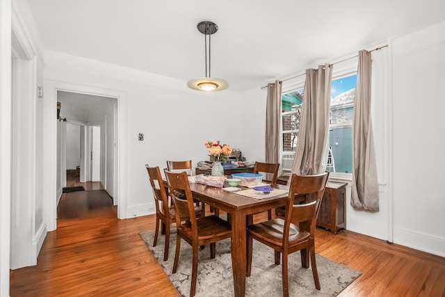 dining space featuring wood-type flooring