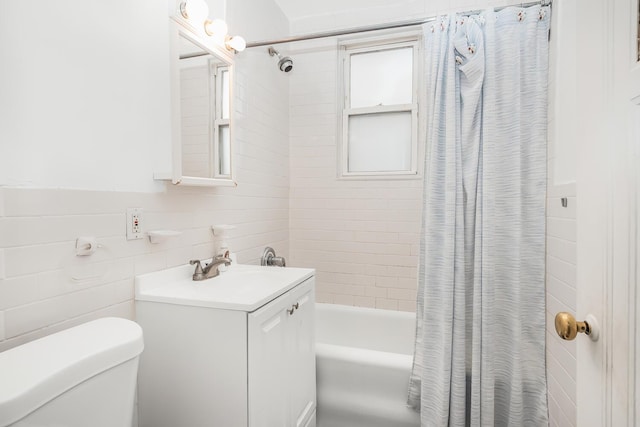 full bathroom featuring toilet, shower / bathtub combination with curtain, and vanity